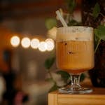 Close-up of a refreshing iced coffee in a stylish glass, perfect for summer.